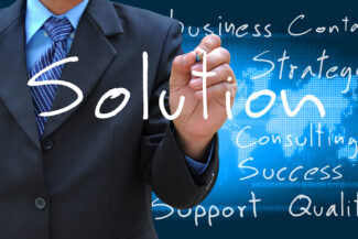 businessman hand writing solution on world map